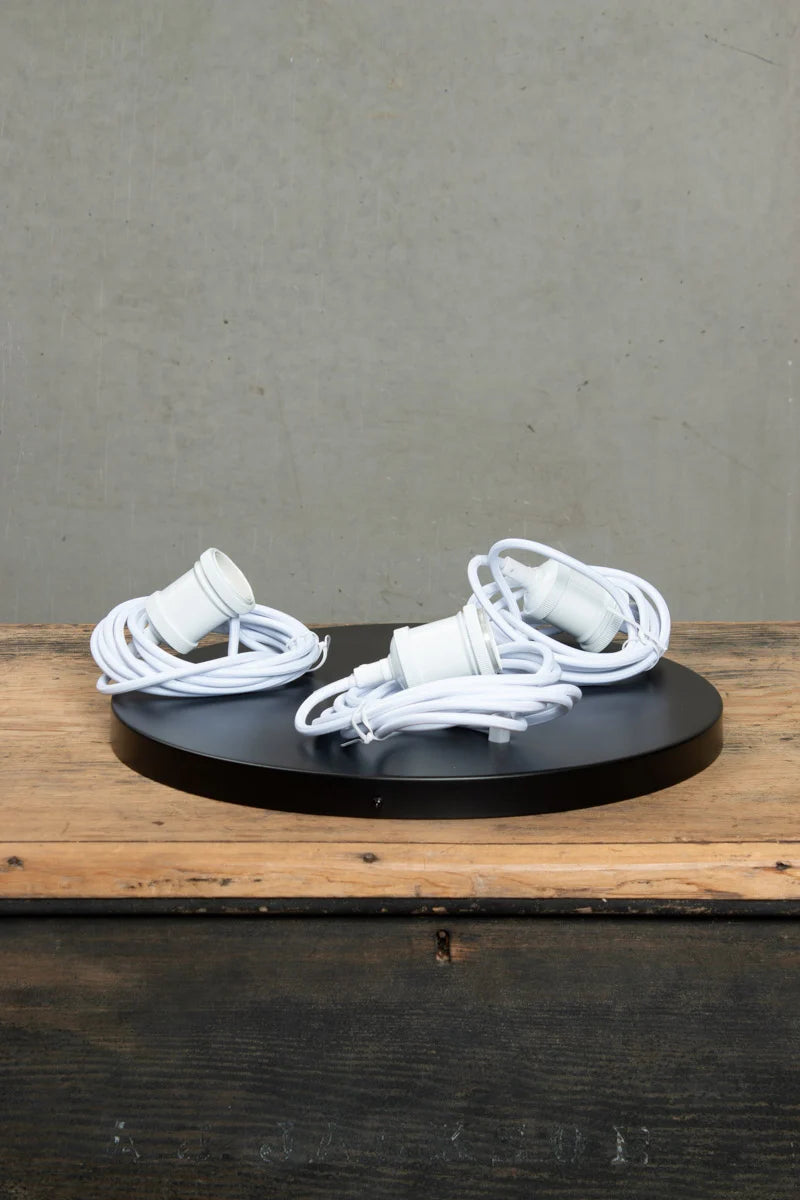 Three white pendatn cords with black ceiling rose 