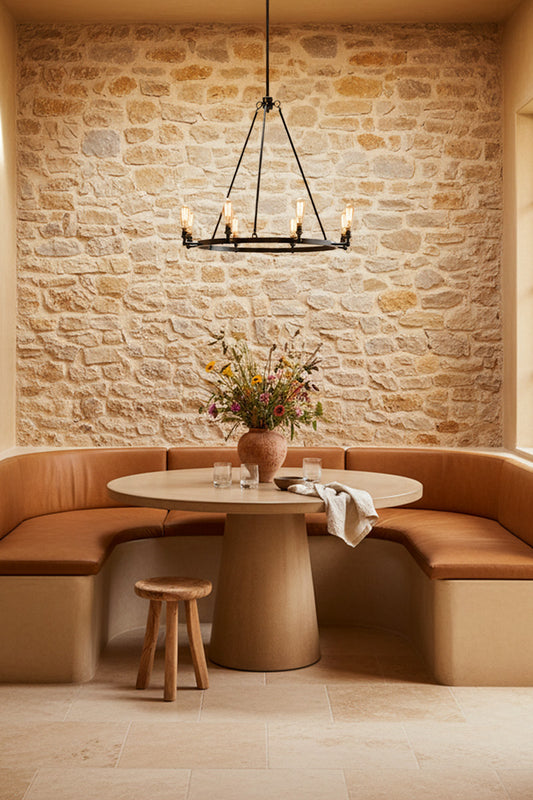 8 light circular chandelier with teardrop bulbs in a rustic modern dining space. 