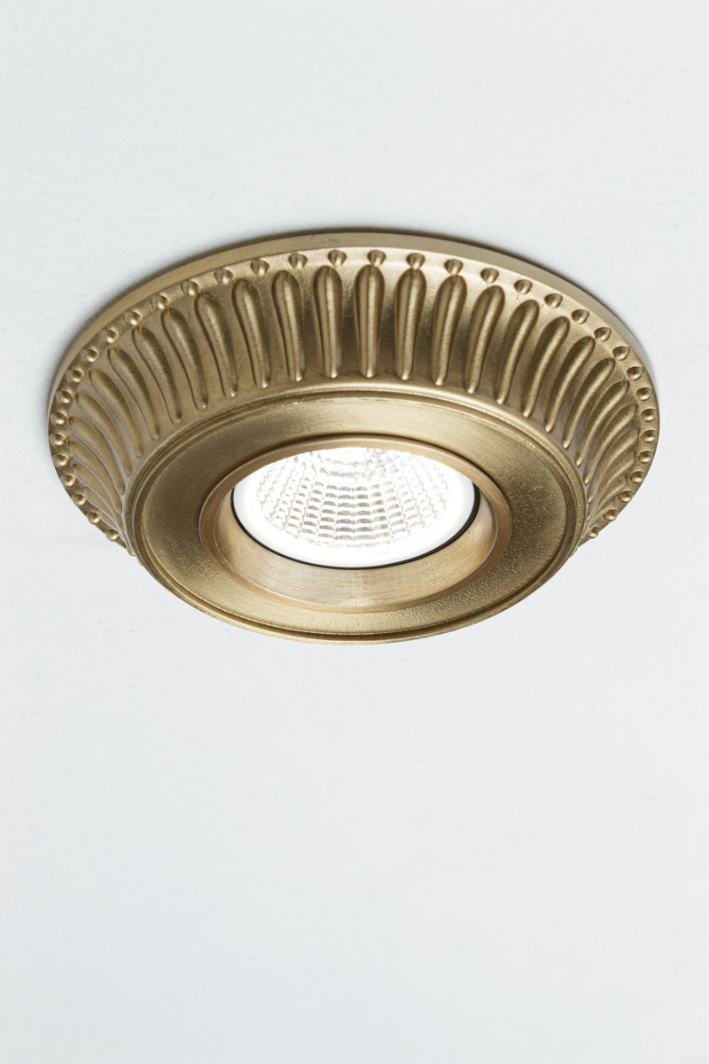 Cast brass cover with fluted detailing along the outer rim is often found in Victorian or Art Deco architecture