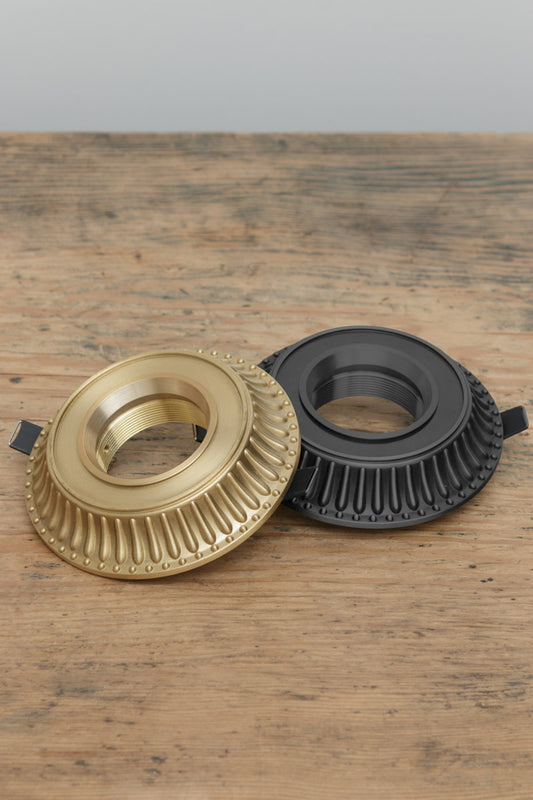 brass downlight covers feature a traditional ridge design that mimics the classic aesthetics of an antique ceiling rose