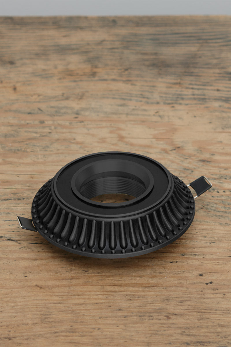 Decorative down light cover is made from brass and finished in black