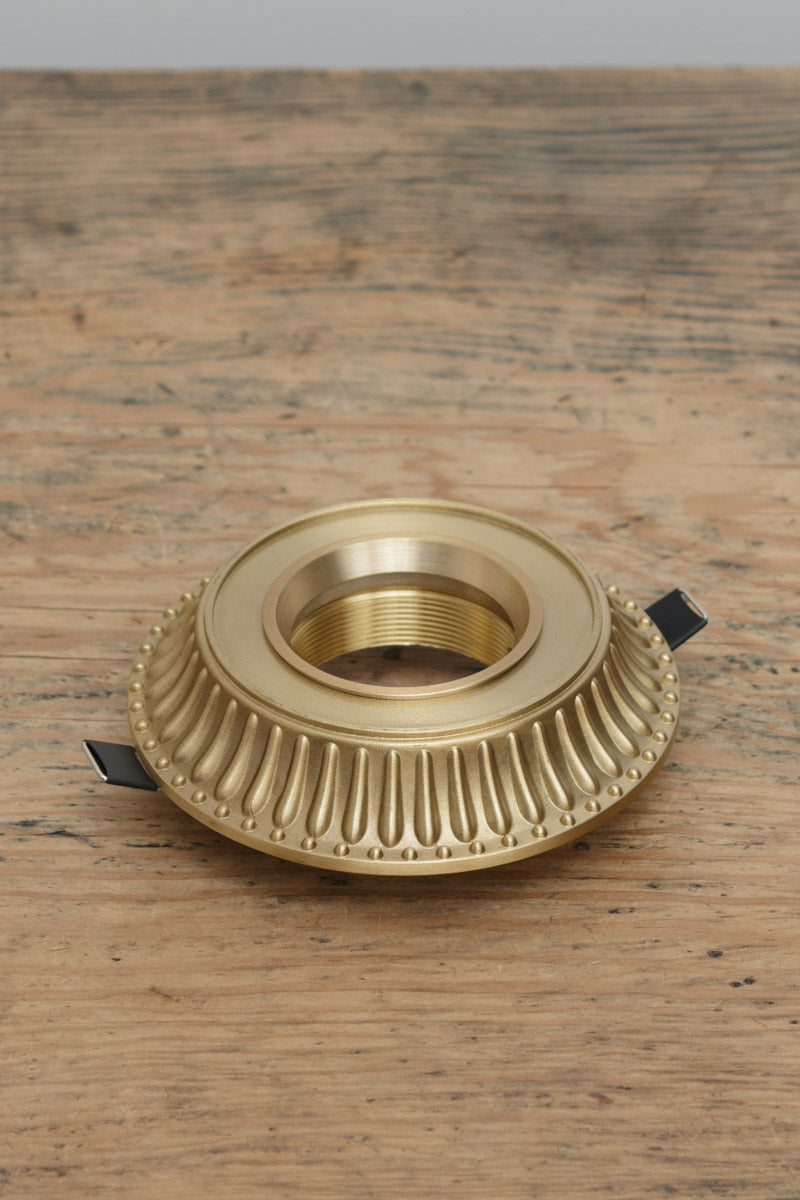Decorative down light cover is made from brass and finished in brass