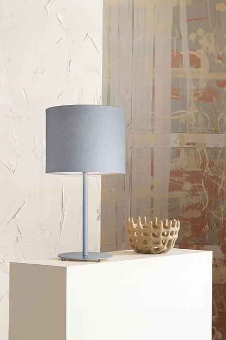 Light blue table lamp above a coffee table