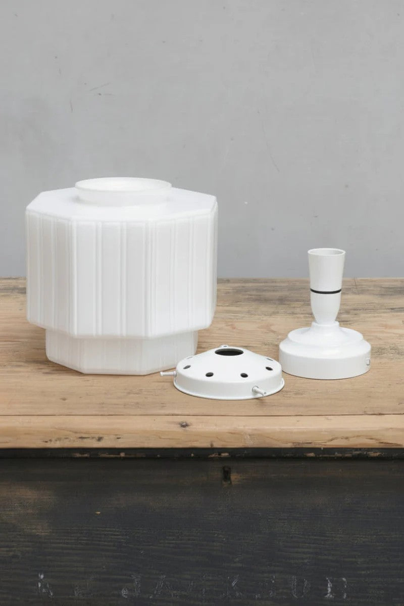 Uninstalled opal glass shade with arte deco inspired detailing, a white batten holder and a white gallery. 