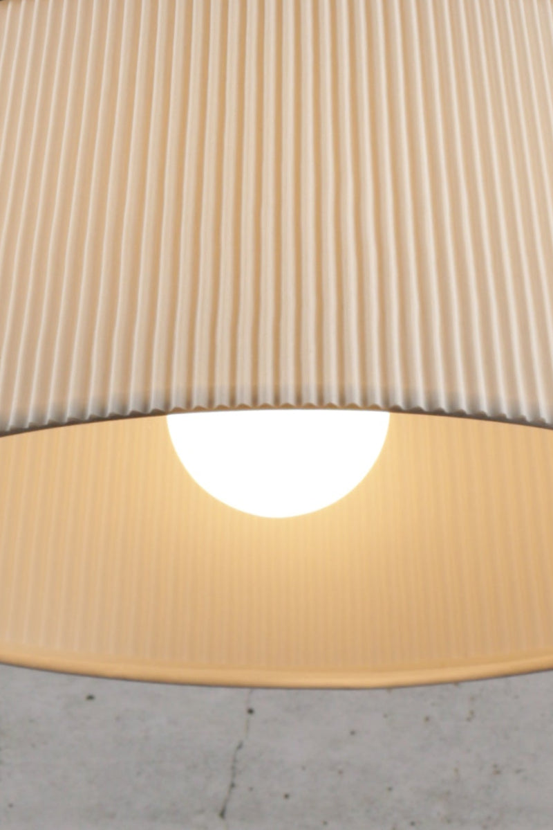 Crosby Pleated Pendant Light turned on with bulb