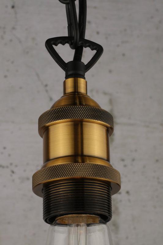 close up of the antique brass chain saw suspension