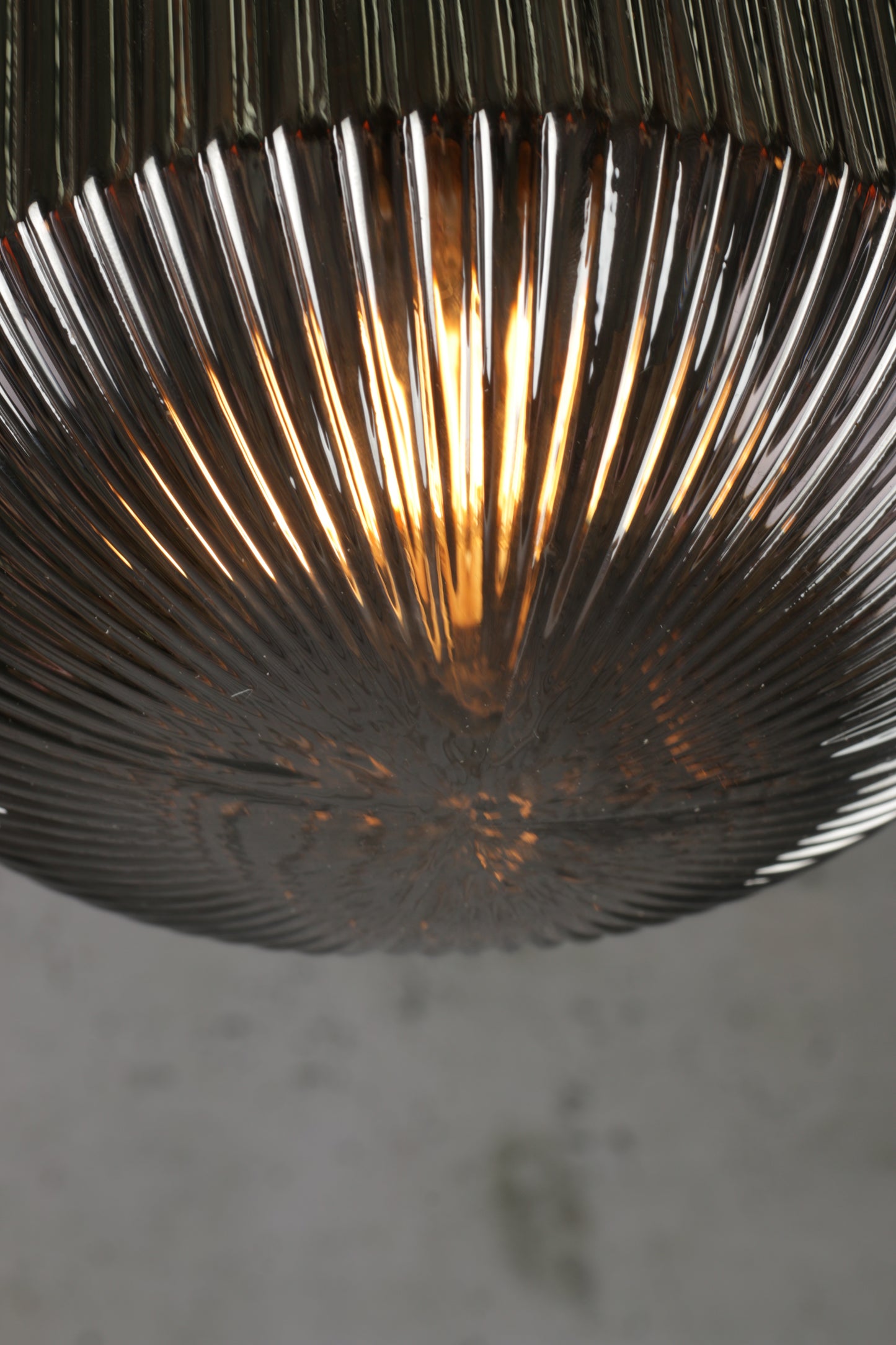 Close up of the base of the grey reeded glass steller shade. 