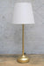Gold table lamp with whie fabric shade off