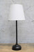 Black table lamp with white fabric shade not on
