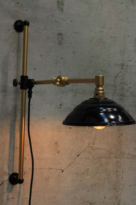 Swing Arm Wall Lamp in gold arm finish with black Bakelite shade