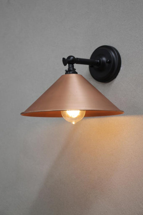 Small bright copper cone wall light with black arm