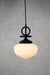 small opal glass pendant light with black disc cord with black gallery