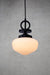 small opal glass pendant light with black disc cord with black gallery