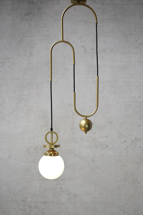 Opal pendant light with gold brass pulley cord and disc with matching gallery