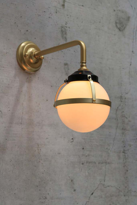 Huxley wall light with gold 90 degree arm and small opal shade