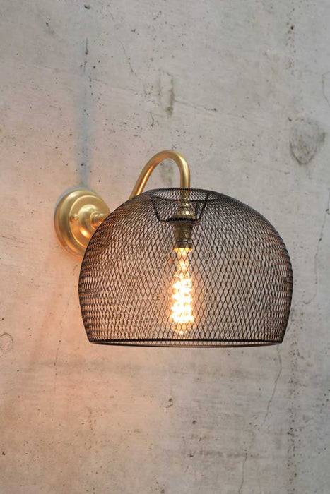 Gold/brass wall light with metal basket shade