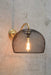 Gold/brass wall light with metal basket shade