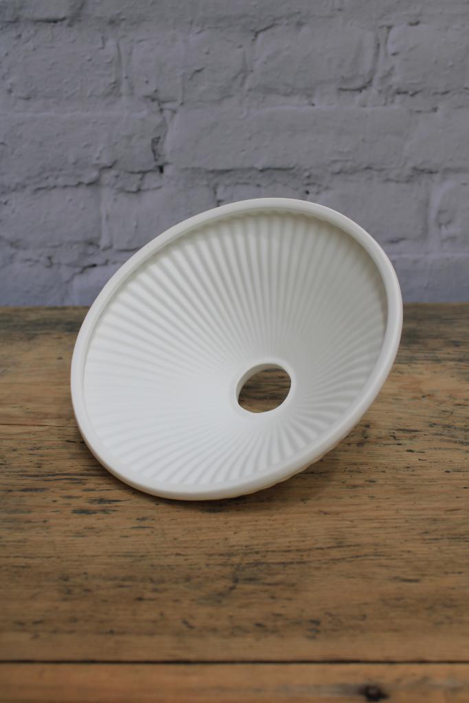 Underside of the white, pleated ceramic shade. 