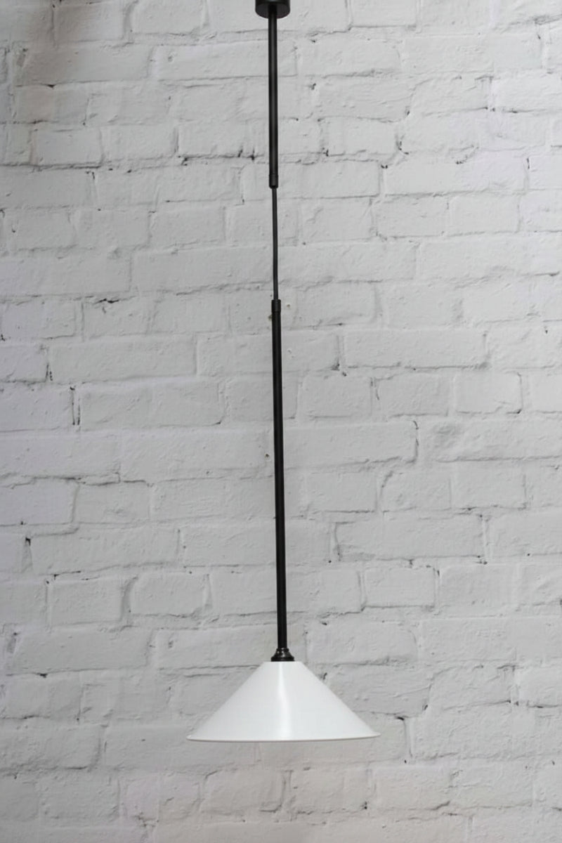 White cone shade on a black industrial pendant style suspension. 