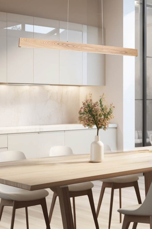 Lancelin LED Wood Linear Light hanging in a bright kitchen and dining space. 