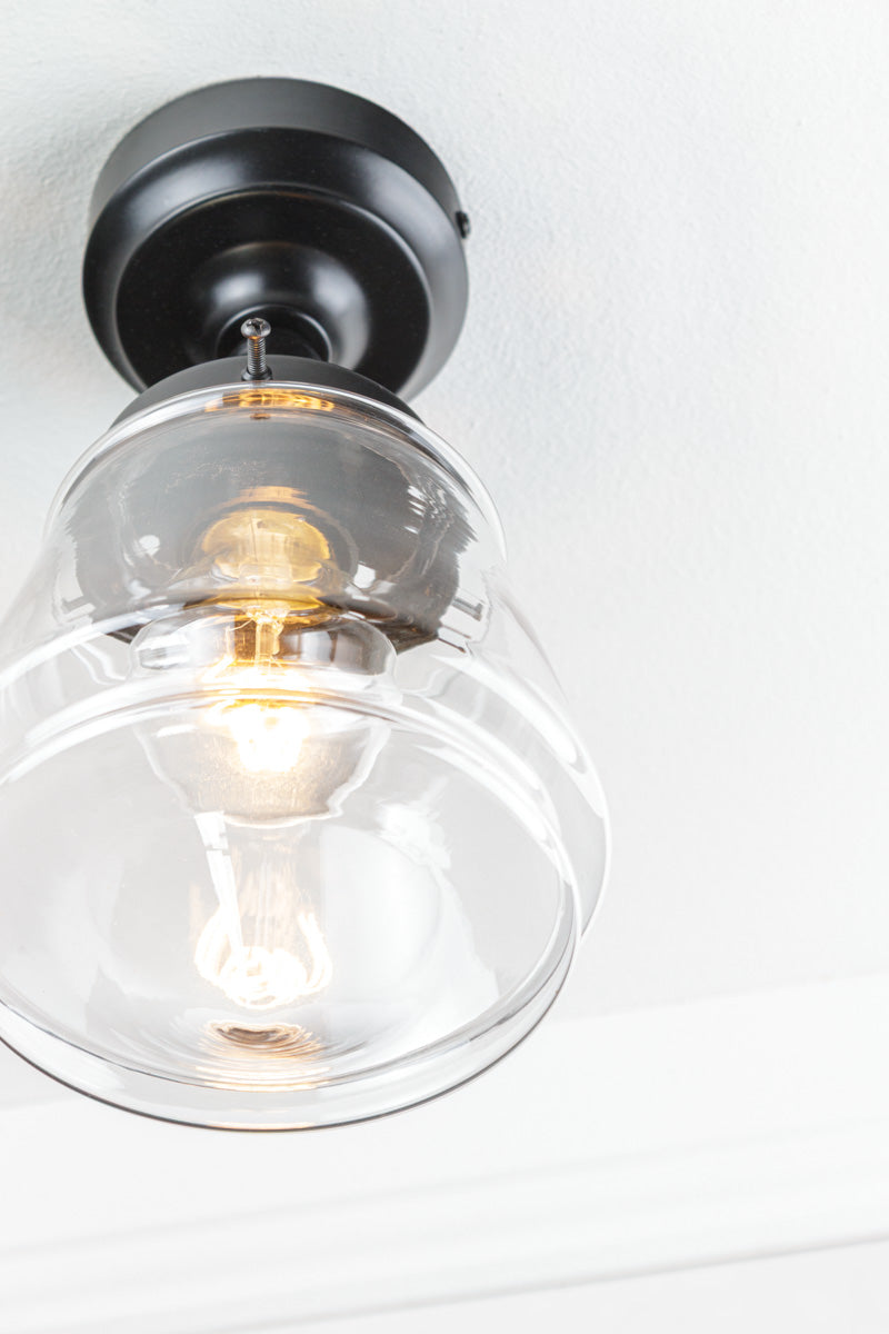 Close up of the clear Deco inspired glass shade and black batten holder. 