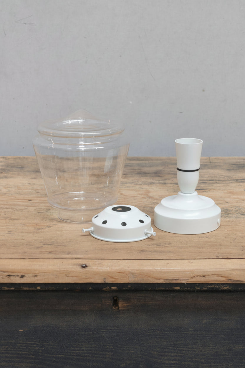 Clear Deco inspire glass shade sitting on a timber bnch with a white gallery and batten holder. 
