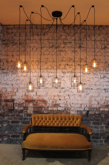 Cage industrial pendants light with 9 pendant cords that hang drape or spread in different combinations