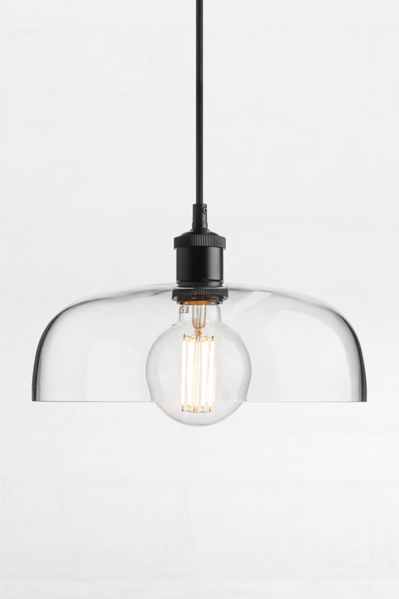 Clear glass shade with black cord and black lampholder. 