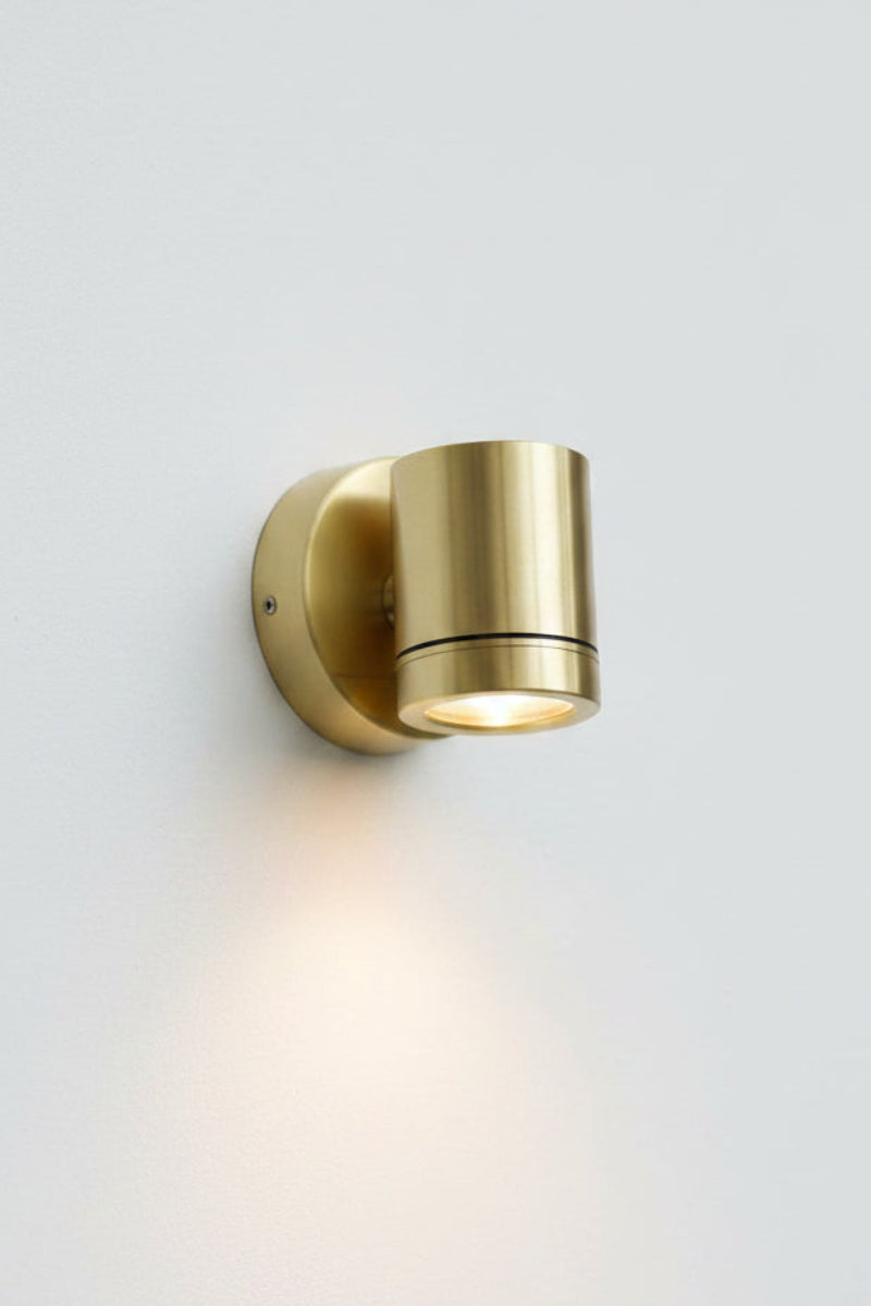 Polished brass single fixed spotlight.