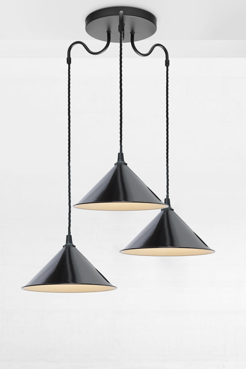 Large cone shades in black on a black three arm gooseneck multi drop fixture.