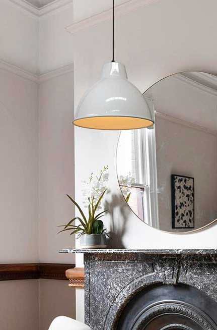 White loft pendant with black fabric cord in a dining room