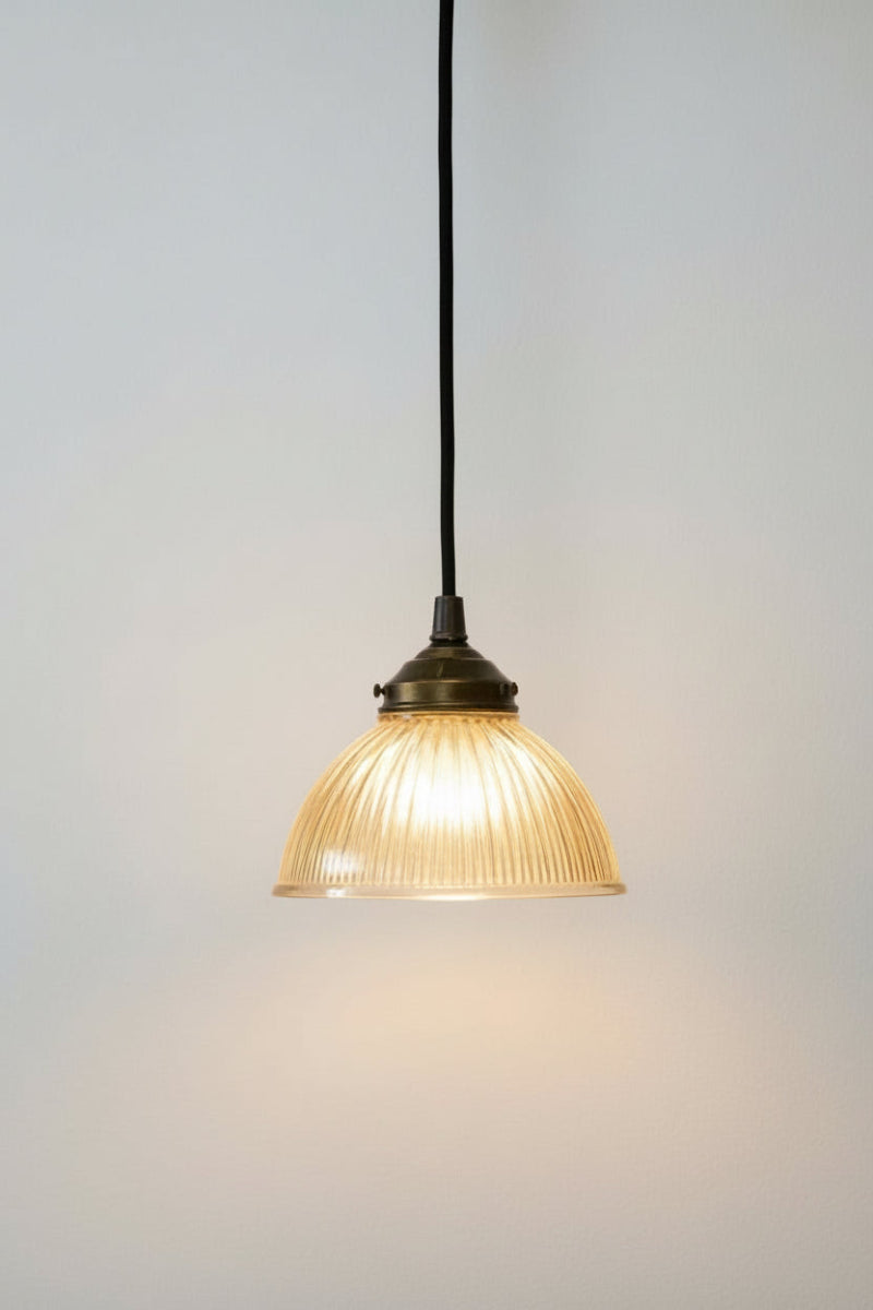 Amber glass shade with reeded detailing on a black pendand cord