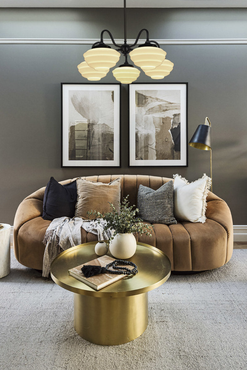 Black 5 light gooseneck chandelier with opal shades in a modern lounge room. 