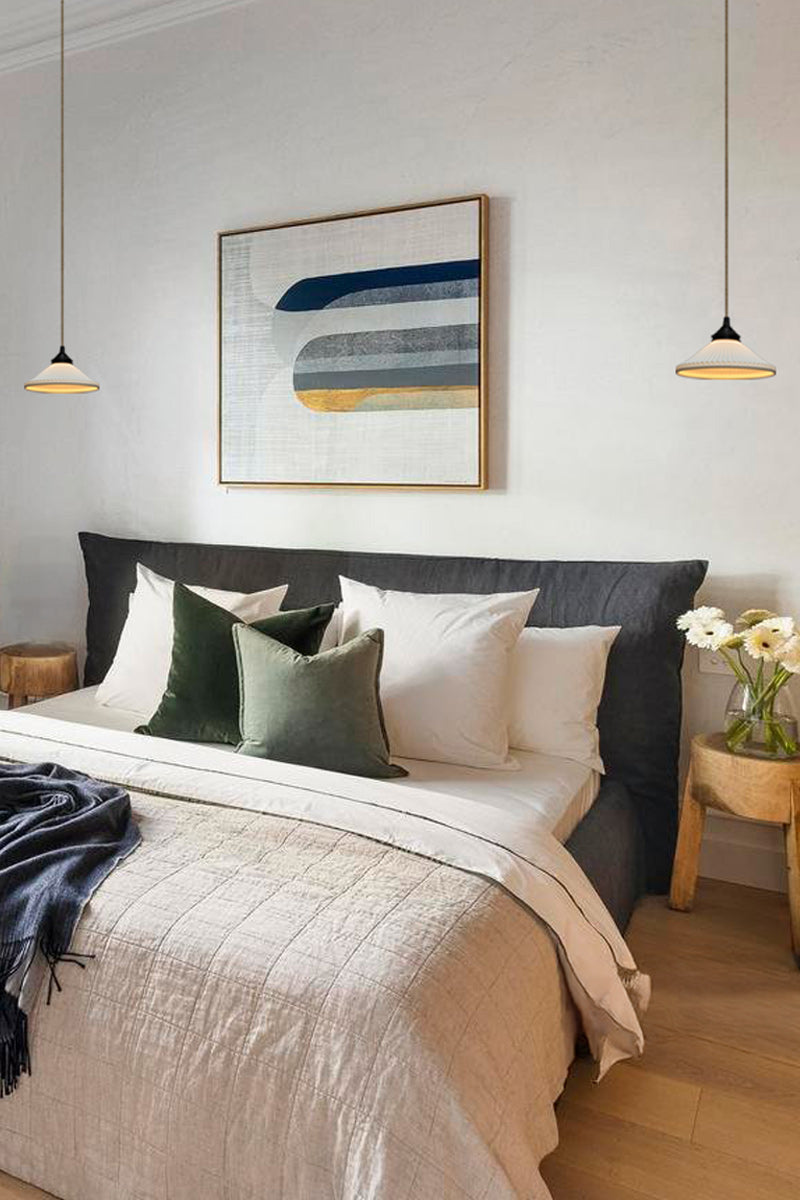 Ceramic pleasted shades on jute cord with black hardware as bedside lights. 