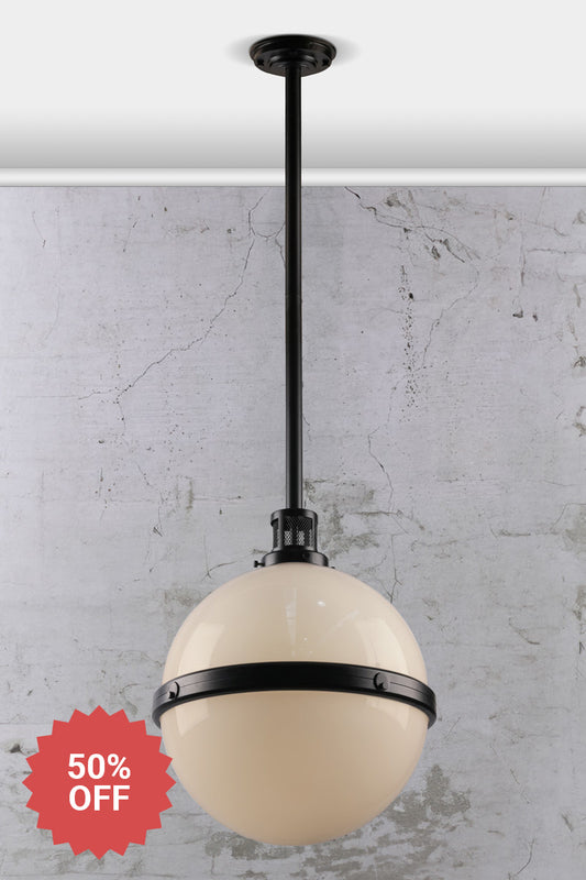 Black steel pole pendant light with an opal glass ball shade and industrial detailing. 