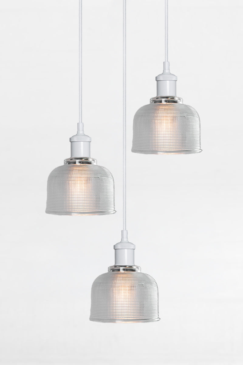 3 light multi pendant with black ceiling rose, white pendant cords and crosshatch clear glass shades. 