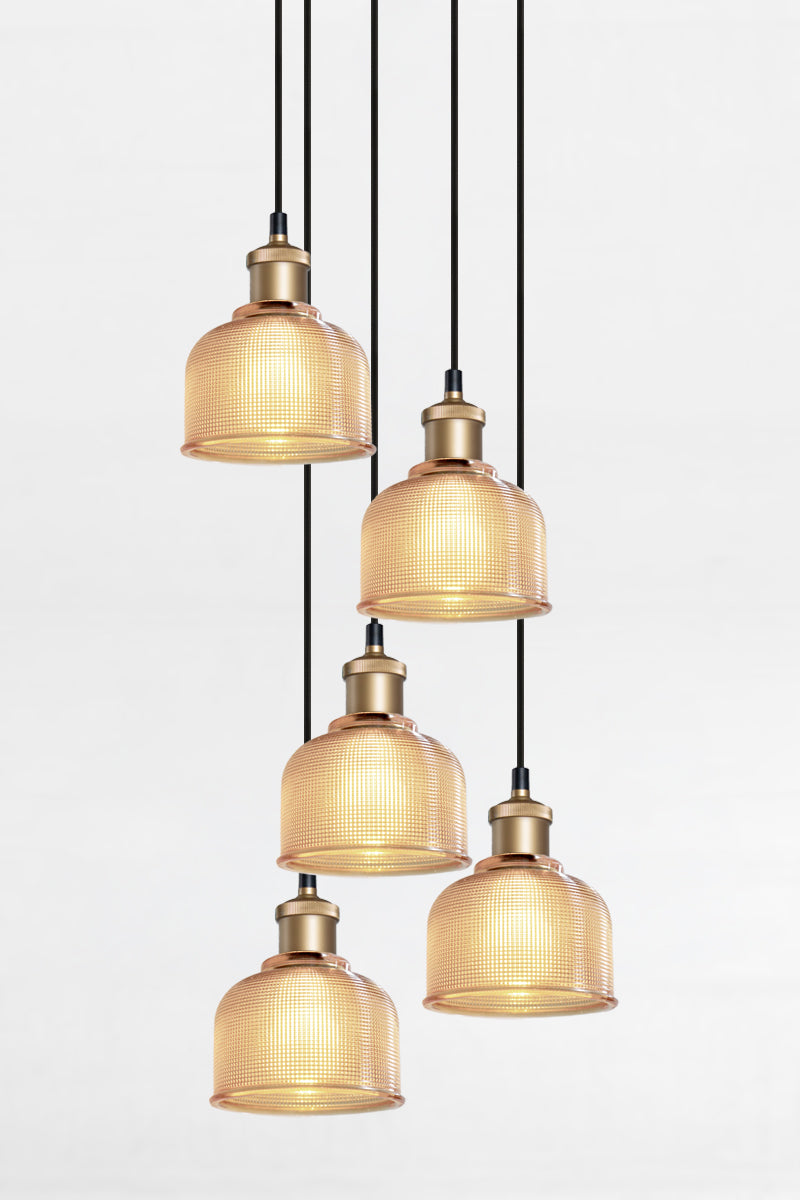 5 light multi pendant with black ceiling rose, black pendant cords, gold/brass lampholders and crosshatch glass amber shades. 