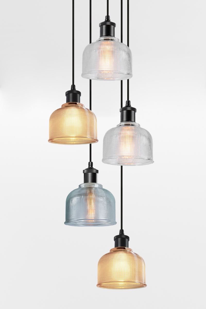 5 light multi pendant with black ceiling rose, black pendant cords and crosshatch glass shades in a mix of amber, clear and blue. 