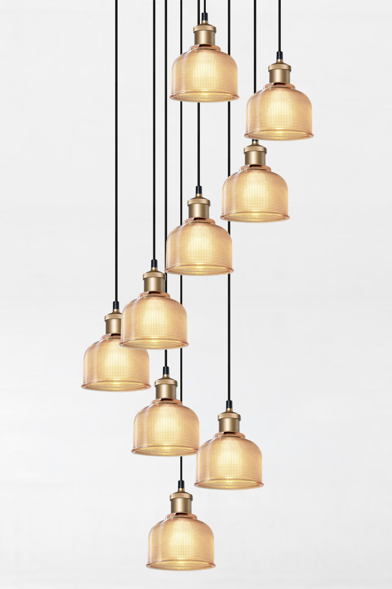 9 light multi pendant with black ceiling rose, black pendant cords, gold/brass lampholders and crosshatch glass amber shades. 
