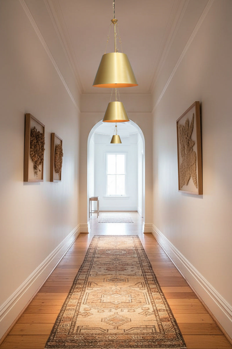 3 brass gold pendant down a hallway