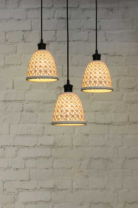 A 3-drop light chandelier featuring small ceramic shades and a black pendant cord.