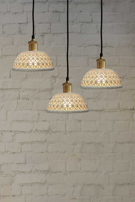 A 3-drop light chandelier featuring large ceramic shades and a gold/brass pendant cord.