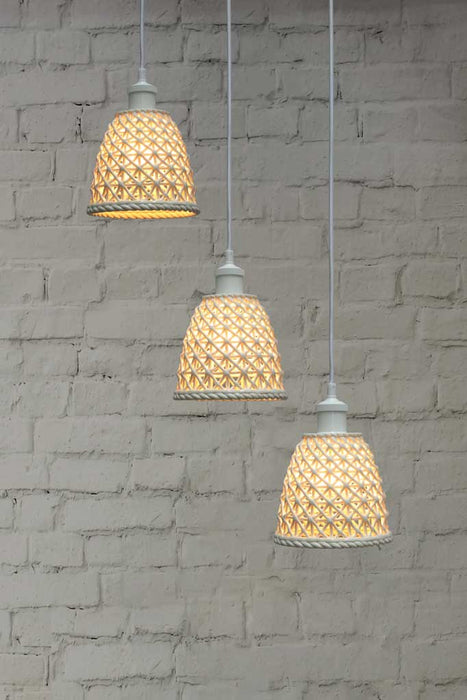 A 3-drop light chandelier featuring small ceramic shades and a white pendant cord.