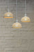 A 3-drop light chandelier featuring large ceramic shades and a white pendant cord.