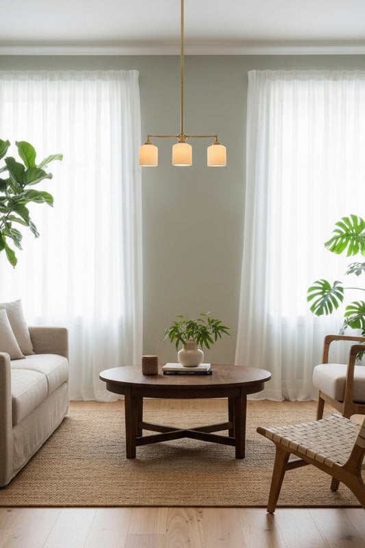 Gold/Brass three light chandelier suspended over coffee table