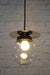 clear pendant light with brass disc