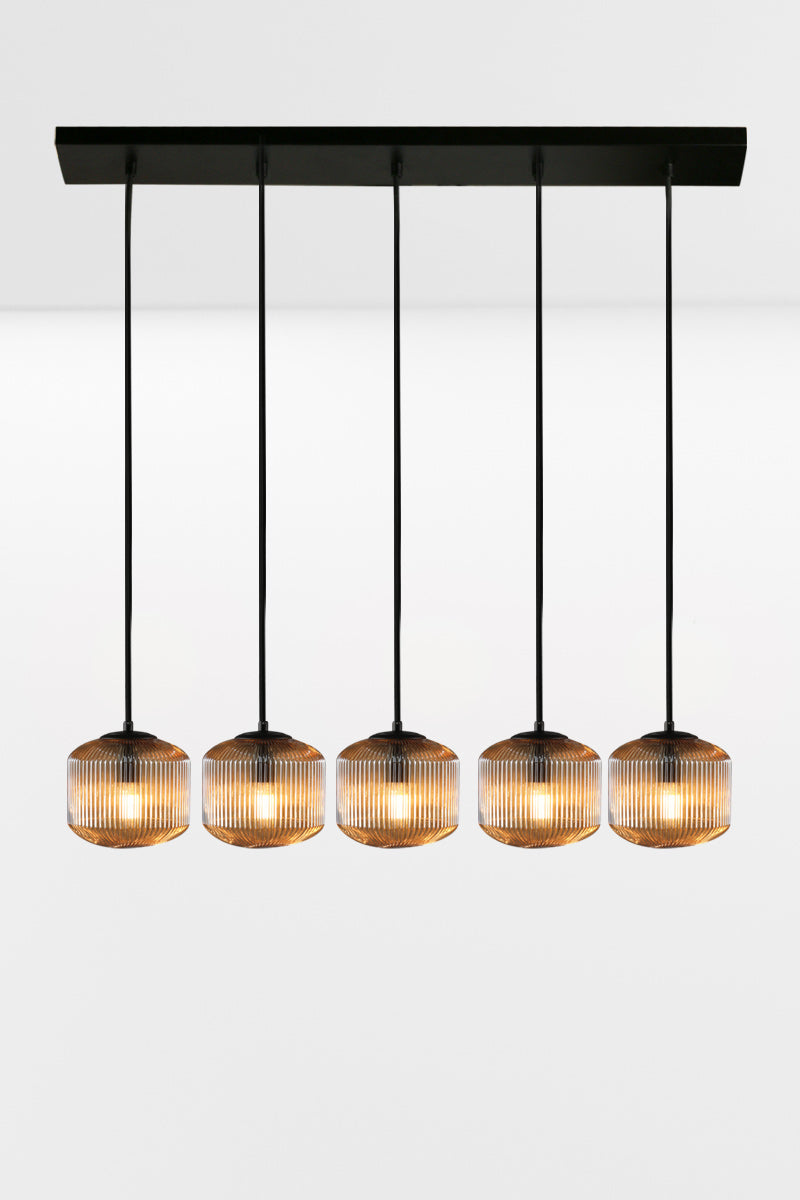 5 drop linear light with amber reeded glass shades in a horizontal  configuration.