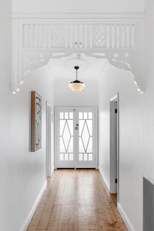Pensacola Deco Pole Pendant with a black pole and large shade has a hallway light. 