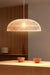 Large rattan pendant light over dining table