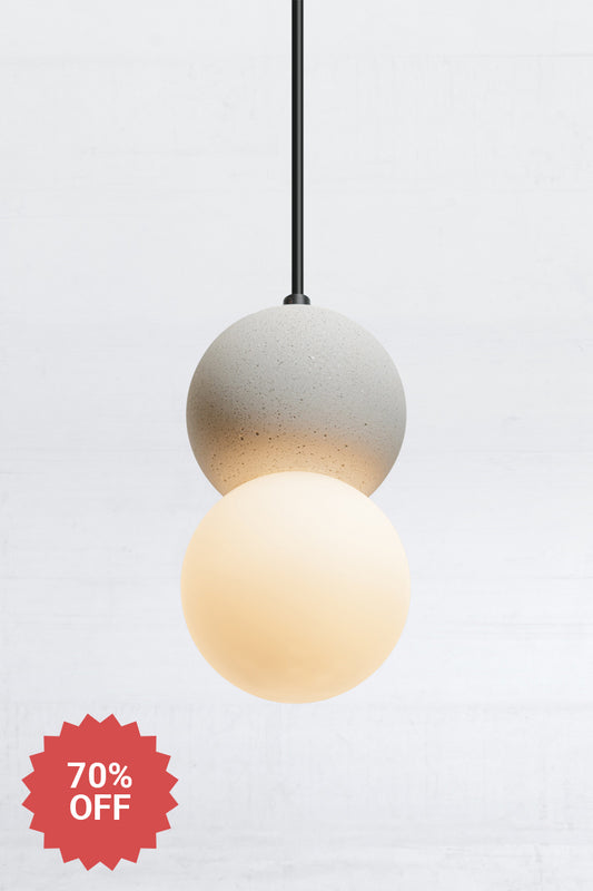 Glass and concrete orb pendant light on black cord